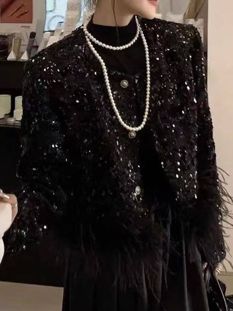 Veste à paillettes noires avec plumes